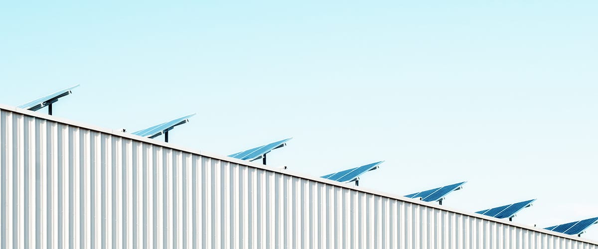 line of solar panels on building roof