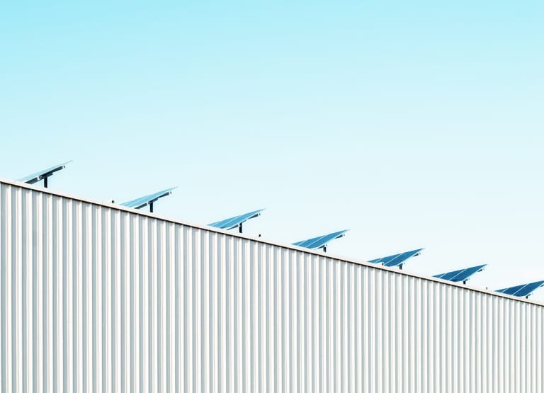 line of solar panels on building roof