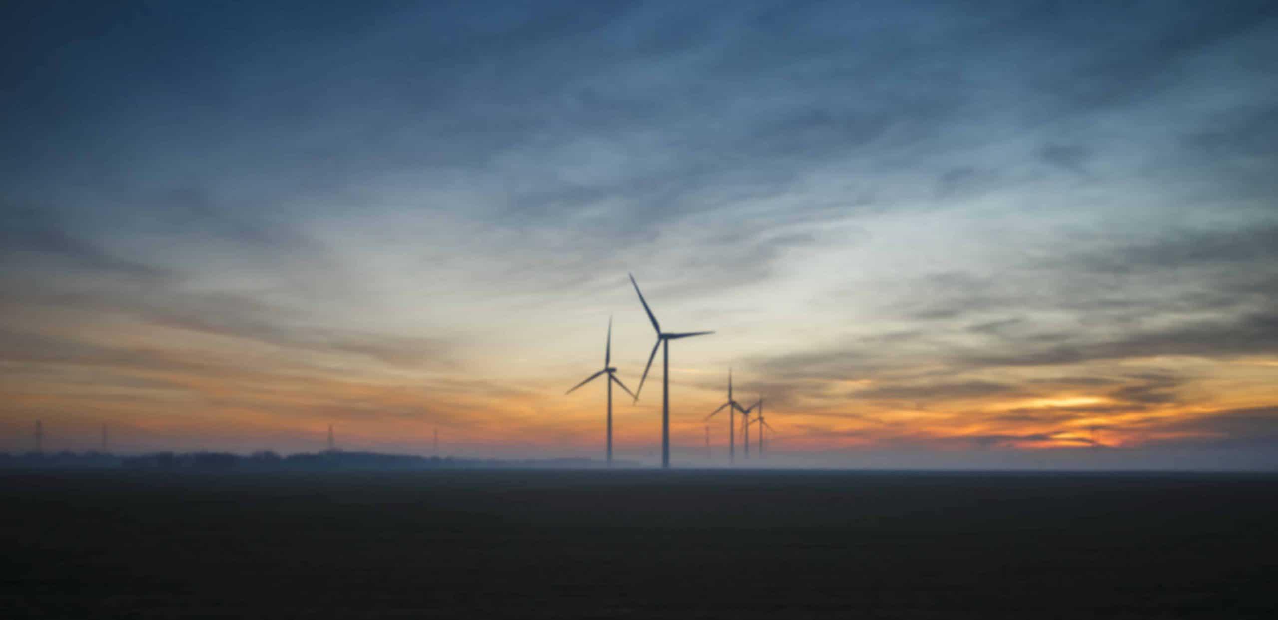 Wind turbines in the field at dusk