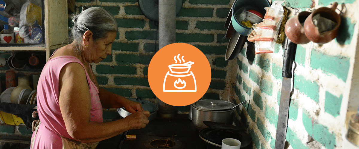 Honduran woman cooking over a stove