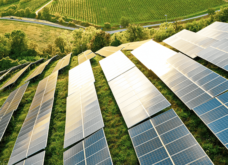 Solar farm with sun shining down