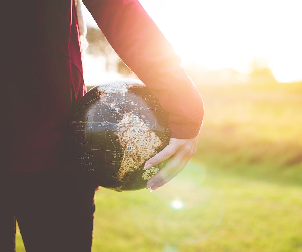 holding globe in sunlight